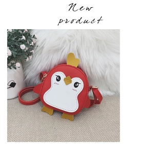 Detail view of red cartoon penguin kids crossbody bag with heart decoration