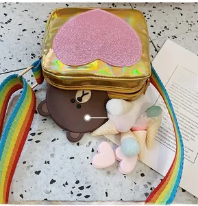 Detail view of mini holographic gold bag featuring pink sequin heart and rainbow strap