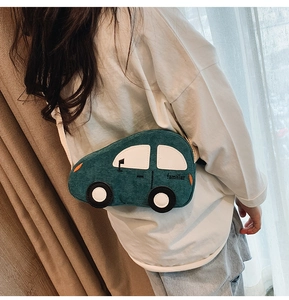 Detail of green corduroy car-shaped kids waist bag with familiar embroidery