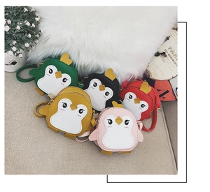 Detailed view of five colorful penguin cartoon leather shoulder bags for children