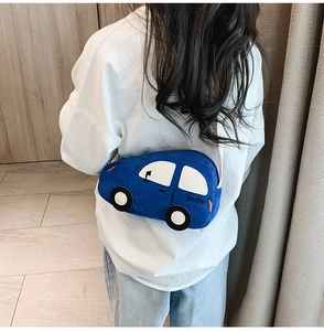 Blue corduroy car-shaped kids waist bag worn by a child in a cozy indoor setting