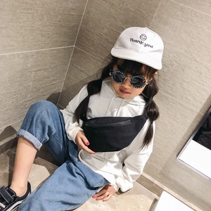 Kids black canvas chest bag for girls styled with casual hoodie and denim outfit