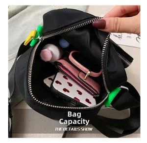 Top-down view showing internal capacity of black nylon crossbody bag with daily items