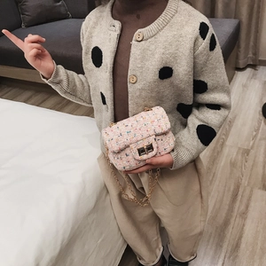 Kids fashion set with a pink tweed chain bag and a beige polka dot knit cardigan