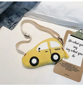 Detail of yellow corduroy kids car bag with familiar embroidery and soft cotton strap