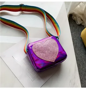 Macro detail of laser leather child bag with glitter heart and rainbow strap