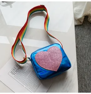 Detail of blue laser leather kids square bag with pink sequin heart and rainbow strap