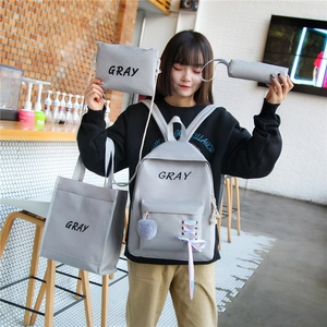 Ensemble 4 pièces sac à dos scolaire gris avec texte 'GRAY' et pompon pour étudiantes