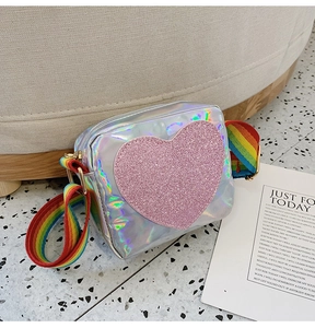 Detail of colorful rainbow strap and holographic heart crossbody bag for girls