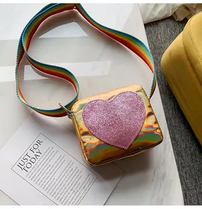 Detail of holographic small crossbody bag with sequin heart and rainbow strap