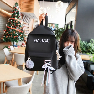 Sac à dos d'école en nylon noir à la mode avec nœud rose et breloque pelucheuse