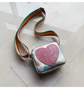 Detailed macro view of holographic kids crossbody bag with glitter pink heart and rainbow strap