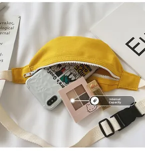 Detail of yellow canvas belt bag showing interior capacity for phone and makeup