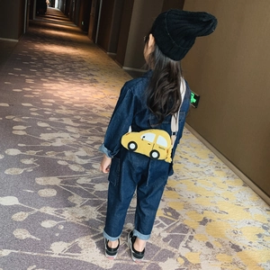 Kids yellow car-shaped crossbody bag with familiar logo on blue denim jumpsuit