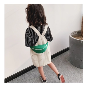 Detailed back view of a child wearing a green canvas waist bag with white zipper detail