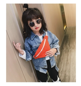 Detailed view of an orange kids fanny pack with white zipper and strap worn cross-body