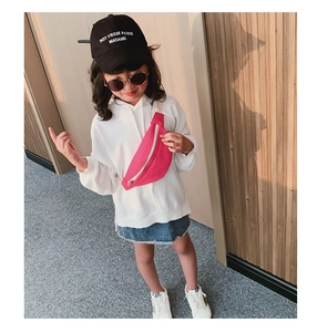 Kids bright pink canvas waist bag with white zipper shown on a young model outfit