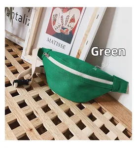 Detail of green canvas kids waist bag with white metal zipper on wooden rack