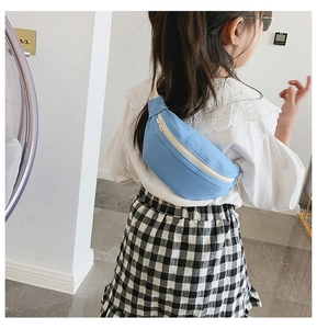 Detail of blue canvas girl fanny pack with contrast zipper on child's outfit