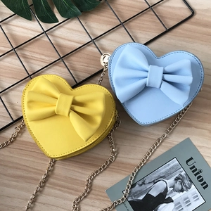 Cute heart-shaped mini crossbody bags with bows and gold chain straps for kids