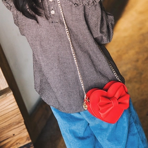 Red heart-shaped crossbody bag for girls with large bow and gold chain strap