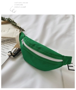 Detail of green canvas kids waist bag with white zipper and adjustable woven strap