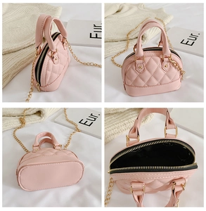 Detail view of pink quilted mini shell bag showing texture, lining and golden chain strap