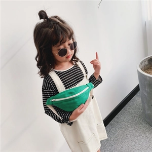 Green canvas kids waist bag with adjustable strap worn as a stylish crossbody chest pack