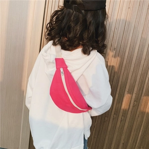 Child wearing hot pink canvas chest bag with white zipper and beige woven strap