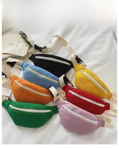 Close-up of seven colorful canvas fanny packs for kids with white zipper detail
