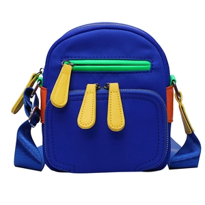 Blue nylon crossbody bag with vibrant green, yellow, and orange color-block details