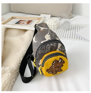 Detail of kids dinosaur chest bag featuring 3D cartoon patch and camo pattern
