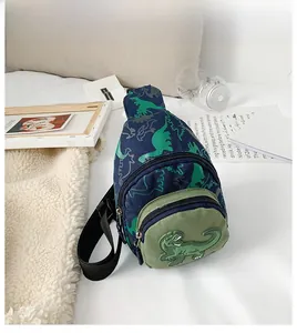 Detail of navy blue kids' dinosaur chest bag with adjustable strap and green pocket