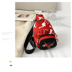 Detail of red kids dinosaur chest bag with a white silhouette and 3D applique on canvas