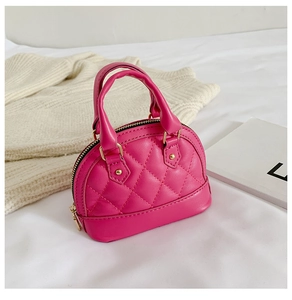 Close-up of bright pink quilted shell bag with gold studs and zipper detail