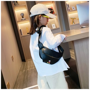 Kid wearing a black Mickey Mouse waist bag with golden zippers and printed details