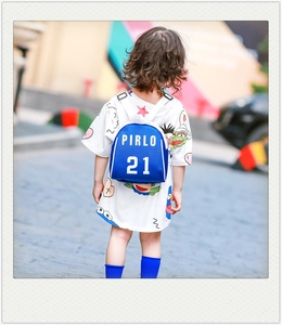 Detail of blue canvas mini kids backpack with PIRLO 21 print worn by a toddler outdoors