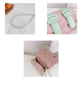 Detail of mini color-block crossbody bag featuring pink PU leather and internal card slots