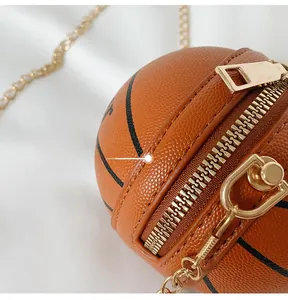Detail of classic orange basketball crossbody bag with lychee texture and gold chain
