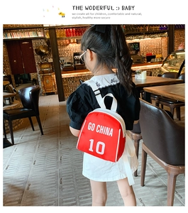 Detail of red kids soccer backpack with white Go China 10 print and nylon texture
