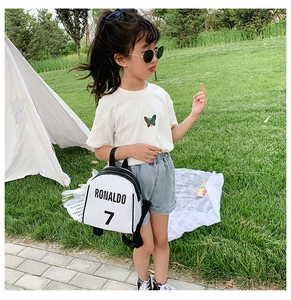 Outdoor view of child wearing white Ronaldo 7 mini backpack for kindergarten sports