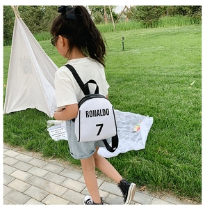 Close-up of the Ronaldo 7 print on a white nylon kids sports backpack in a scenic outdoor setting