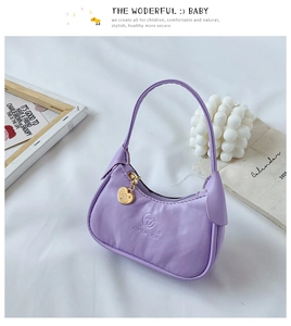 Détail du sac à main violet pour enfant en similicuir avec breloque cœur doré et logo