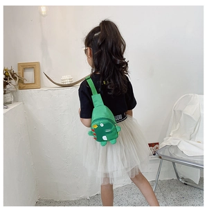 Detail view of green dinosaur kids chest bag with adjustable strap and 3D back fins