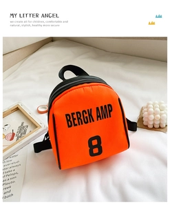 Detail of orange nylon toddler backpack with Bergkamp 8 print on white bedding