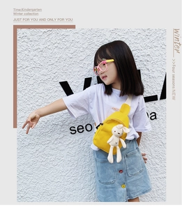 Cute yellow canvas crossbody bag for kids with white plush bunny charm detail