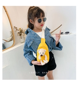 Close-up of a little girl wearing a yellow canvas chest bag with a plush bear decor