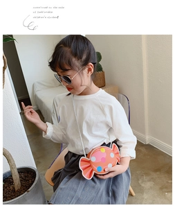 Asian child model wearing a colorful candy-shaped shoulder bag with white braided strap
