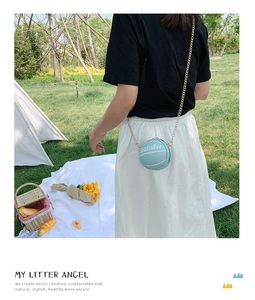 Detail of light blue basketball shaped crossbody bag with gold chain strap for girls