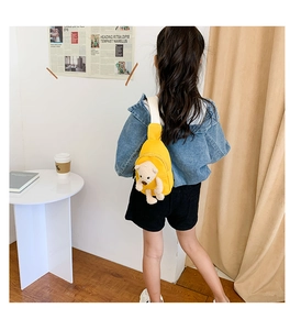 Detail of yellow canvas kids chest bag featuring a 3D plush bear and adjustable strap